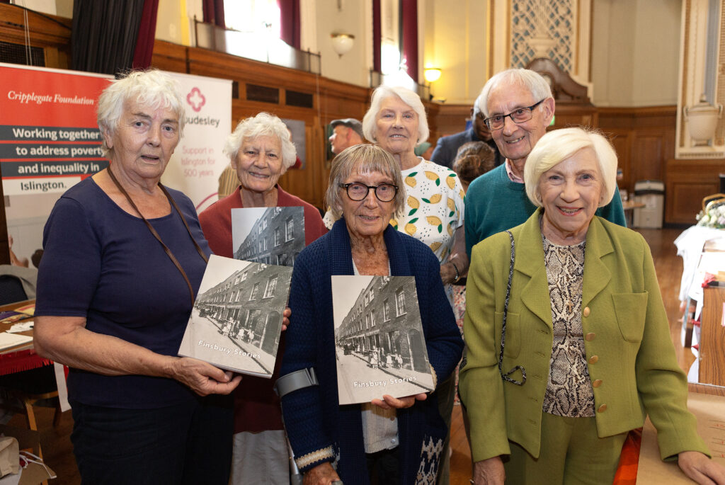 A group of older people holding up a picture
